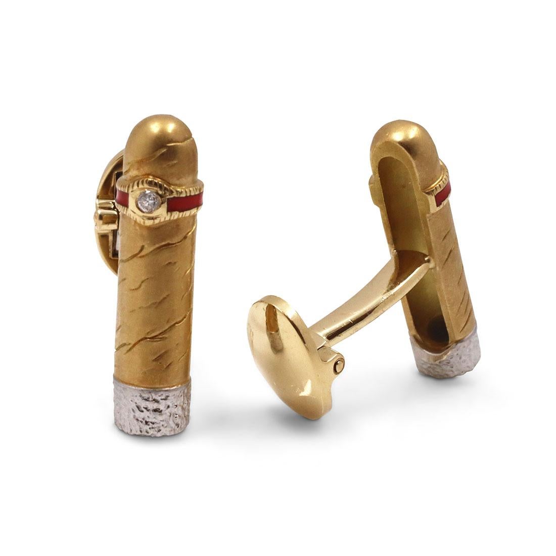 An authentic pair of cufflinks crafted in 18 karat yellow gold and platinum. These striking cufflinks designed as cigars feature a single round diamond centered in the cigar band and a platinum tip that resembles ashes. Stamped PLAT, 750. The