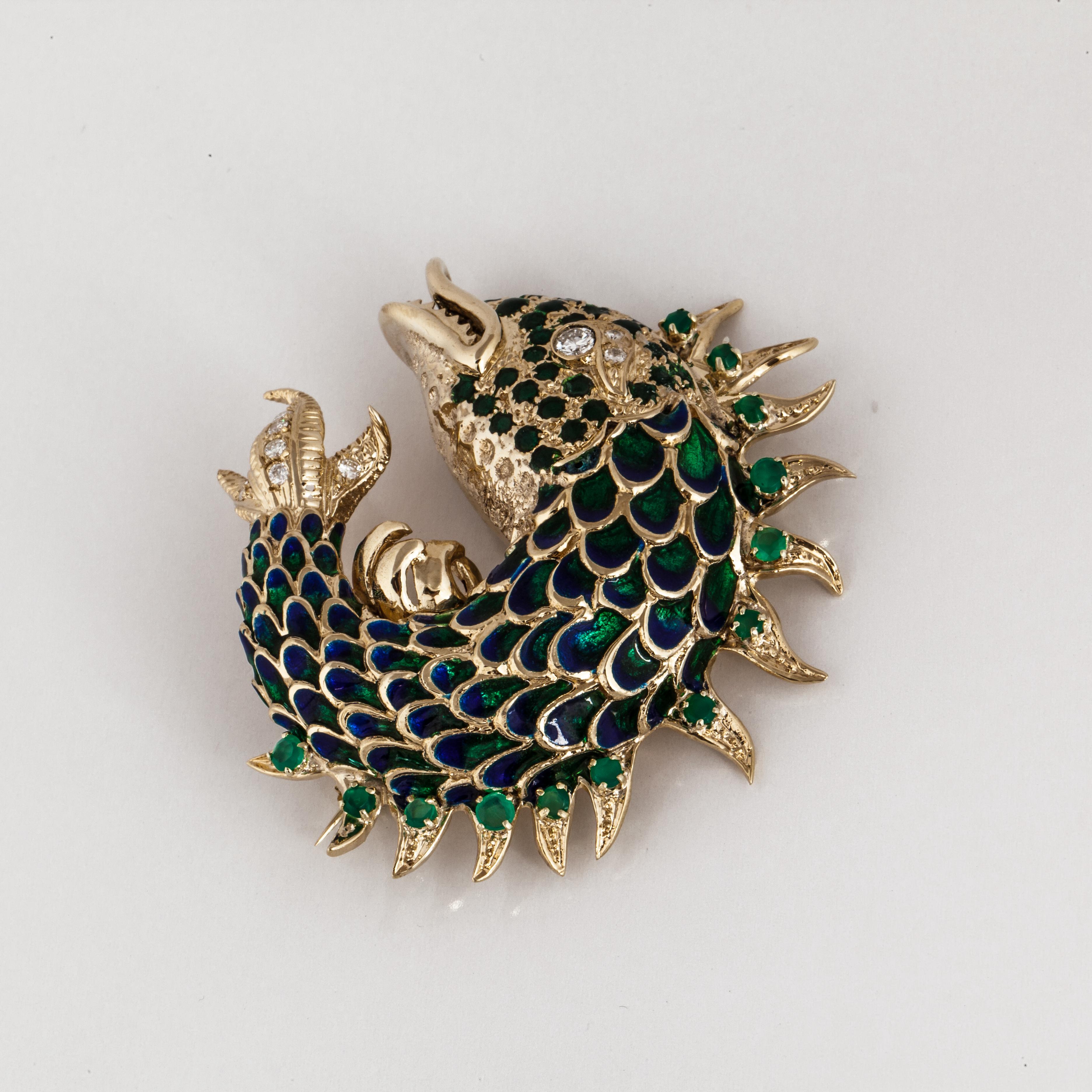 Plique-a-jour enamel fish brooch in blues and greens composed of 18K yellow gold.  The fish has a diamond eye and diamond accents.  There are nine round brilliant-cut diamonds that total 0.55 carats.  There are thirteen round chrysophrase stones set