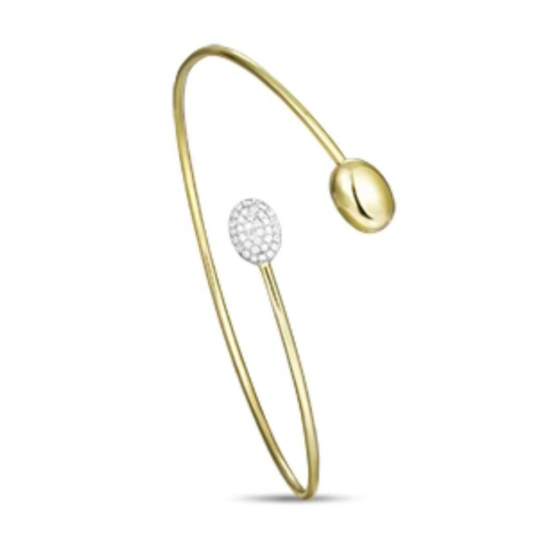 Trendy 14k yellow gold pod bangle with pave set round brilliant diamonds. Wear it stacked with other bangles or on its own. Bangle contains thirty six diamonds H-I color, SI clarity, total carat weight 0.14 ctw. One size fits most. Perfect gift for