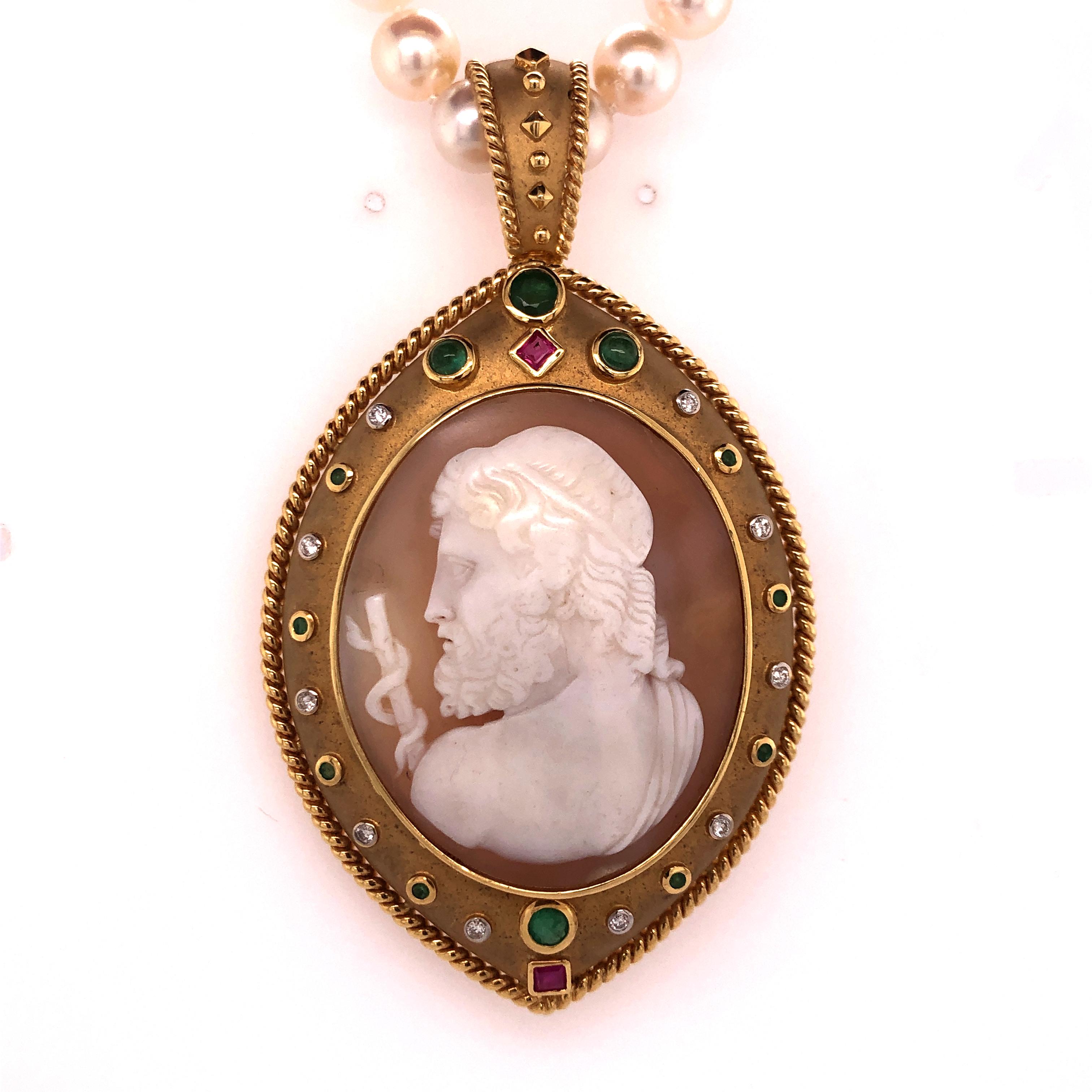 Taking center stage, the Greek god Asceplius, the god of medicine and healing, wields his staff as he looks over his left shoulder in the large cameo that is set into an marquise-esque  18K yellow gold necklace enhancer. The setting is adorned with