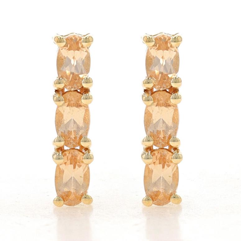 Metal Content: 10k Yellow Gold

Stone Information
Natural Precious Topaz
Treatment: Routinely Enhanced
Carat(s): 1.68ctw
Cut: Oval
Color: Light Peachy Orange

Total Carats: 1.68ctw

Style: Three-Stone Drop
Fastening Type: Butterfly