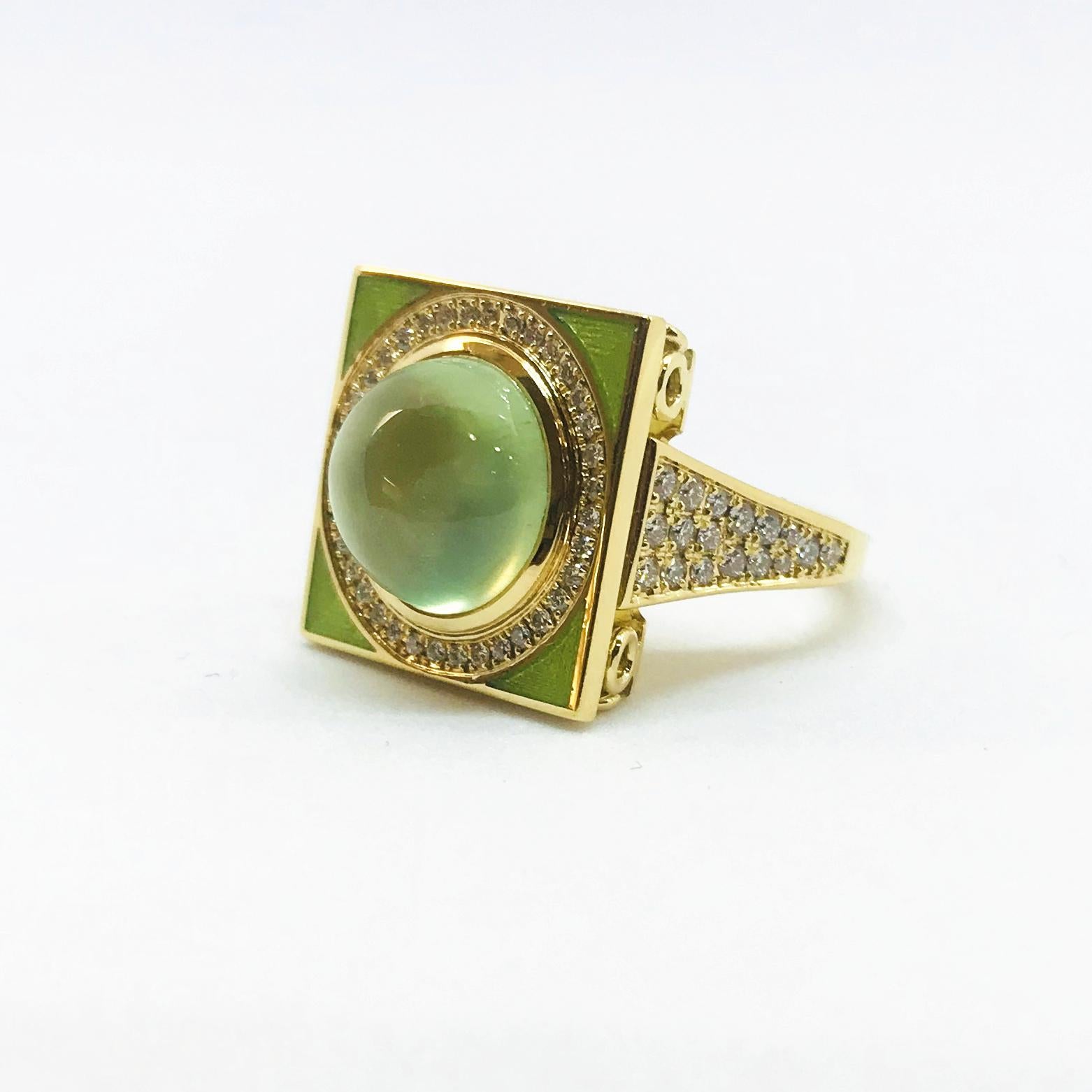 One 18 Karat yellow gold ring with one cabochon-cut green Prehnite gem surrounded by a row of round brilliant cut diamonds centered in a square-shaped top centerpiece (measuring 17 mm L x 17 mm W) with apple green enamel accent. The centerpiece