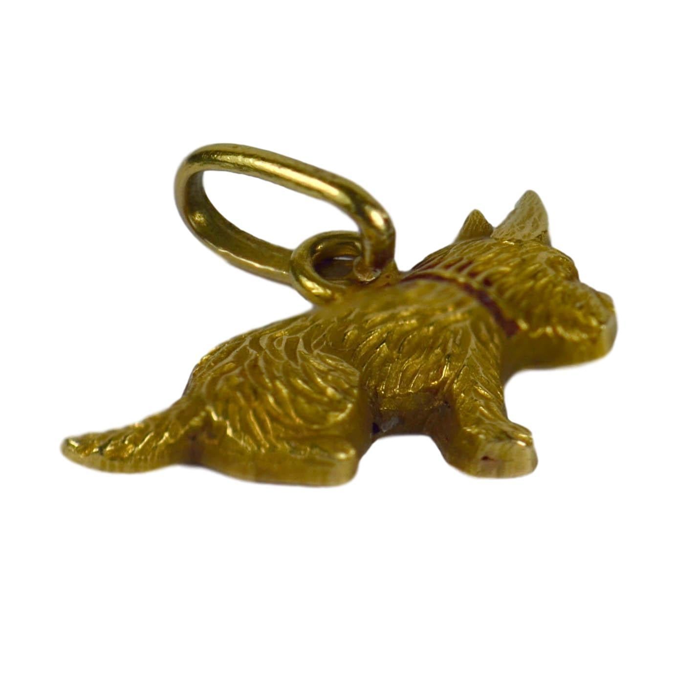 An 18 karat yellow gold charm pendant designed as a small dog with a red enamel collar. Some wear to the enamel. Unmarked but tested as 18k.

Dimensions: 1.3 x 1.5 x 0.2 cm
Weight: 0.42 grams