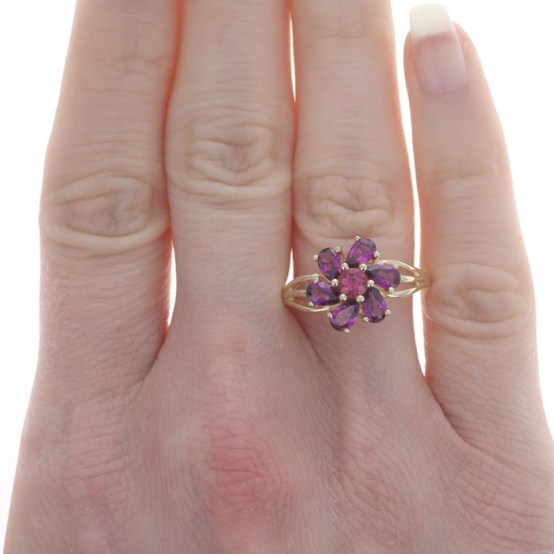 Size: 8 1/4
Sizing Fee: Up 2 sizes for $35 or Down 2 sizes for $30

Metal Content: 14k Yellow Gold

Stone Information
Natural Rhodolite Garnets
Carat(s): 1.80ctw
Cut: Round & Pear
Color: Purplish Red (solitaire) & Reddish Purple (accents)

Total