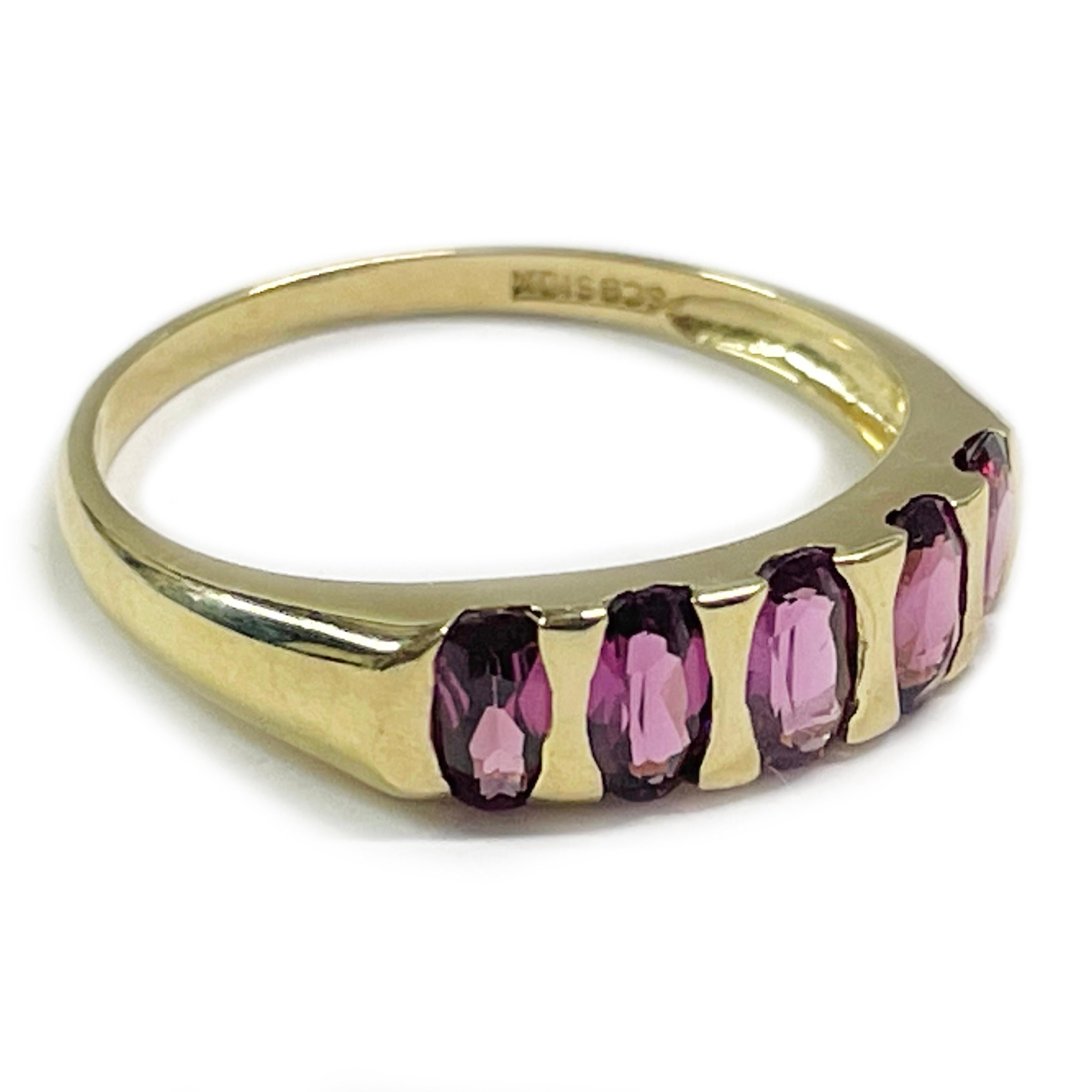 10 Karat Yellow Gold Rhodolite Garnet Ring. This simple yet elegant ring features five bar-set oval garnets. The garnets are medium rose-pink. The garnets measure approximately 5.3 x 2.5mm and have a pink ruby-like color. Stamped on the inside of