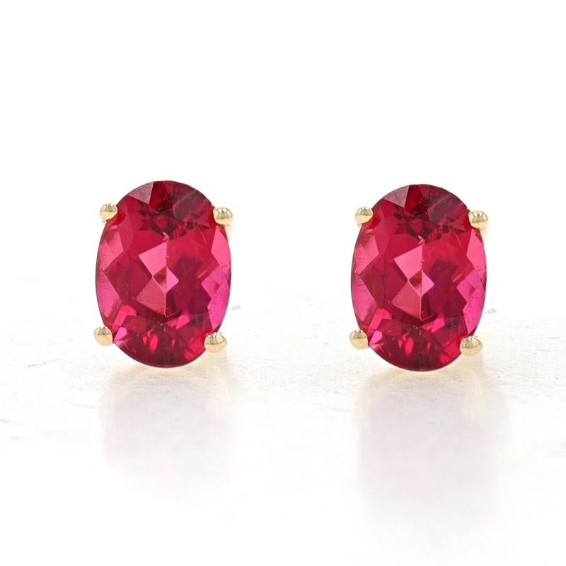 Metal Content: 10k Yellow Gold

Stone Information
Natural Rhodolite Garnets
Carat(s): 2.00ctw
Cut: Oval
Color: Purplish Red

Total Carats: 2.00ctw

Style: Stud
Fastening Type: Butterfly Closures

Measurements
Tall: 9/32