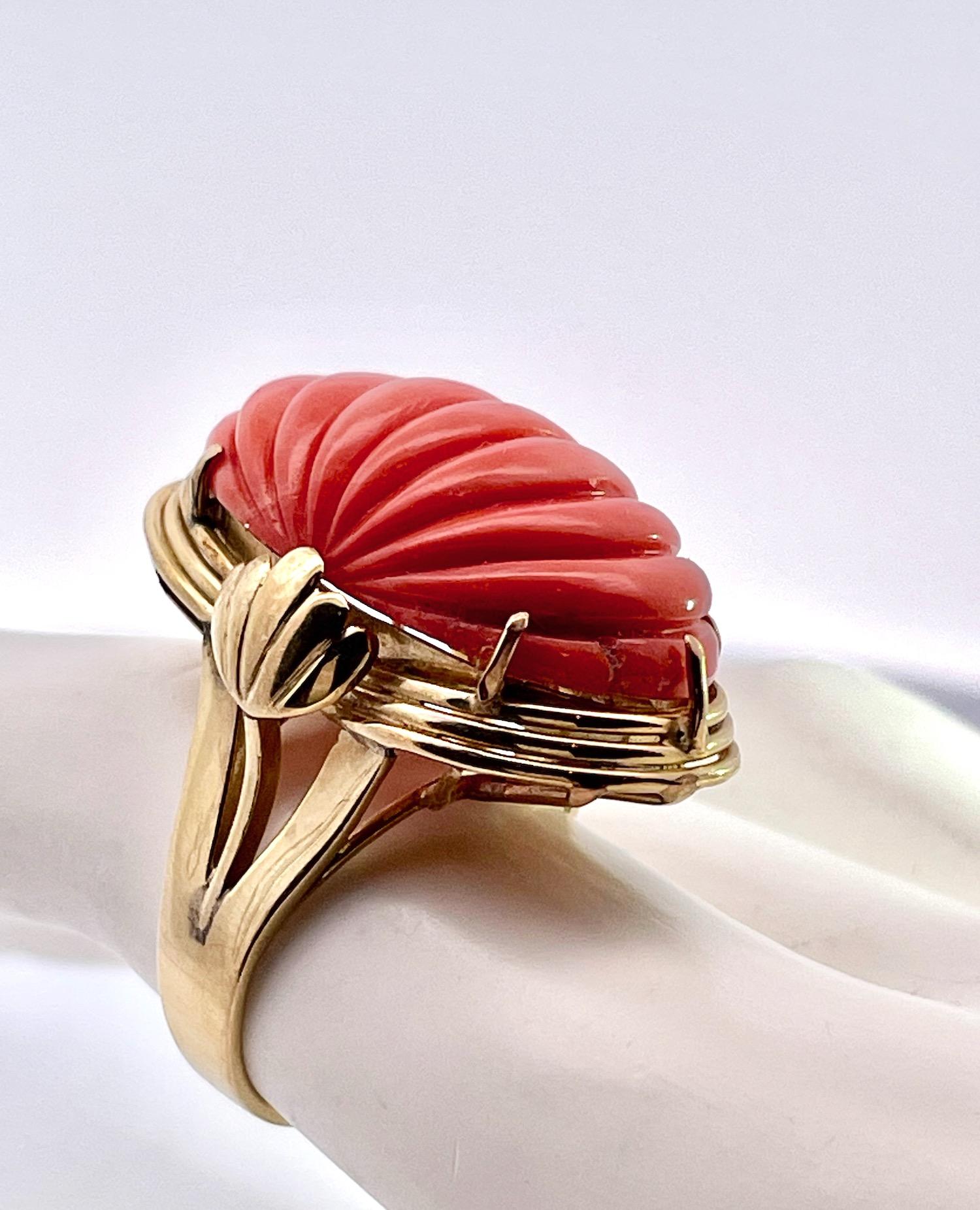 This Ribbed Coral ring is from the 1970's and is in gorgeous condition.
It is made from 14K yellow Gold.  This Coral is carved with 8 ribs or lines that go thru the ring. Beautiful in a unique setting, check it out.  This ring weighs in at 12.61