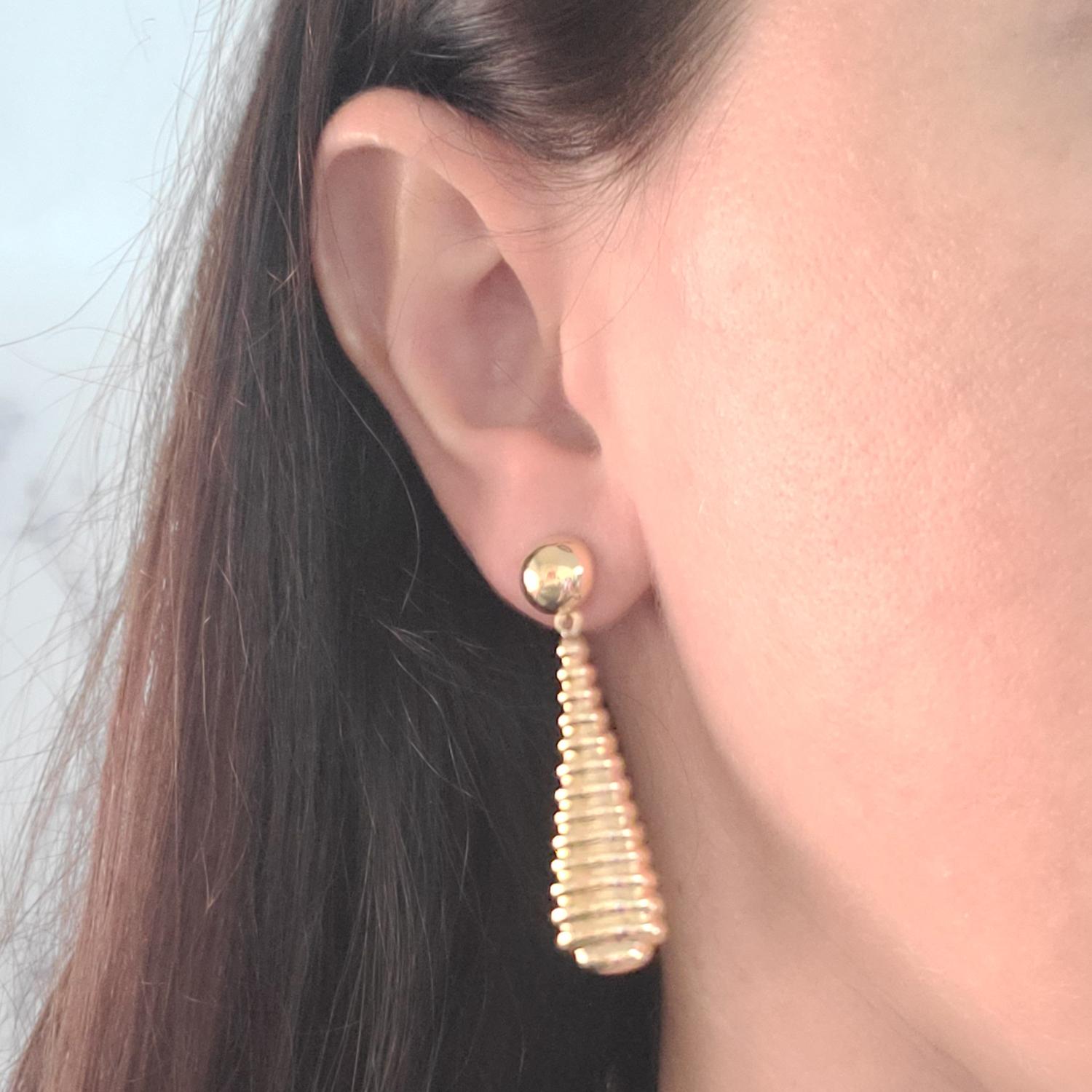 14 Karat Yellow Gold Drop Earrings Featuring Ridged Design. 2 Inches Long. Pierced Post With Friction Back. Finished Weight Is 2.5 Grams.