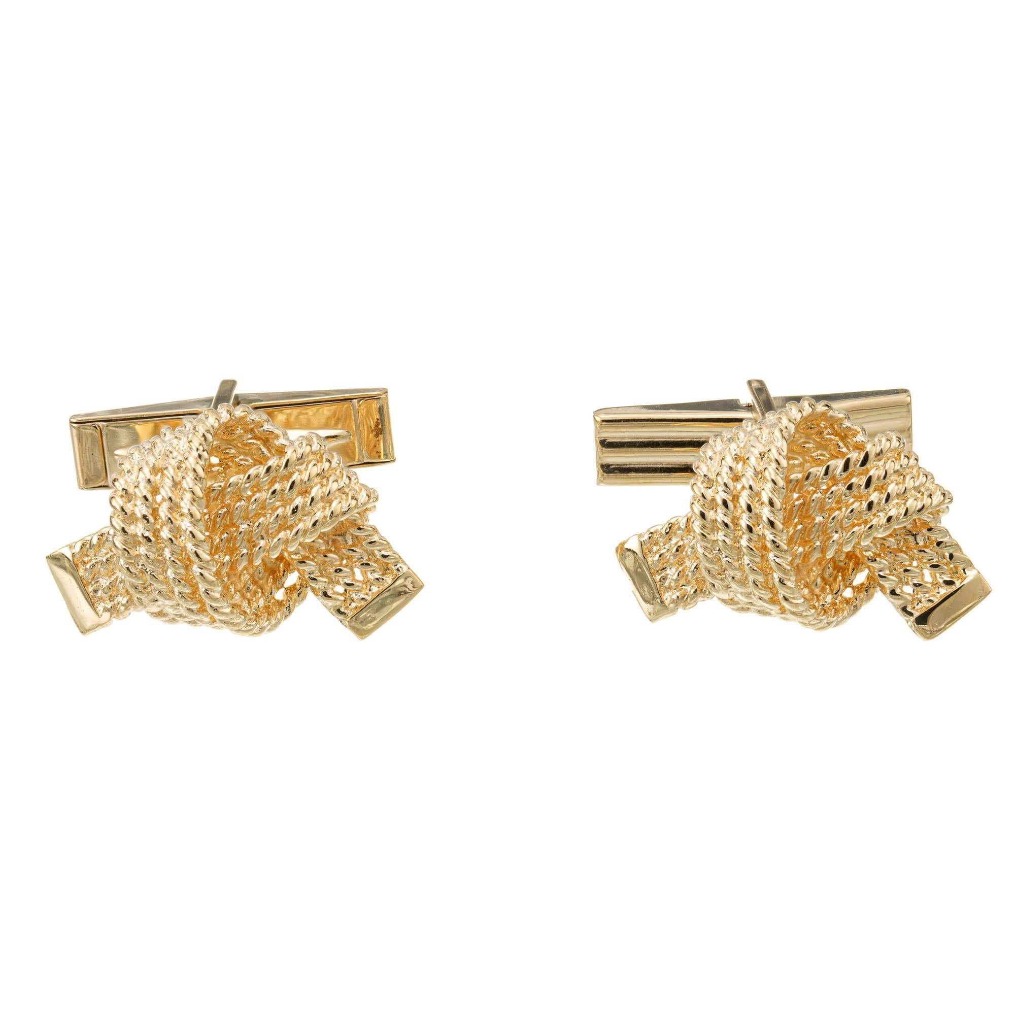 Vintage 1960's Mid-Century bow ribbon style cufflinks in 14k yellow gold. 

14k yellow gold 
Stamped: 14k
12.8 grams
Top to bottom:13.8mm or .5 Inch
Width: 21.7mm or 7/8 Inch
Depth or thickness: 8.7mm
