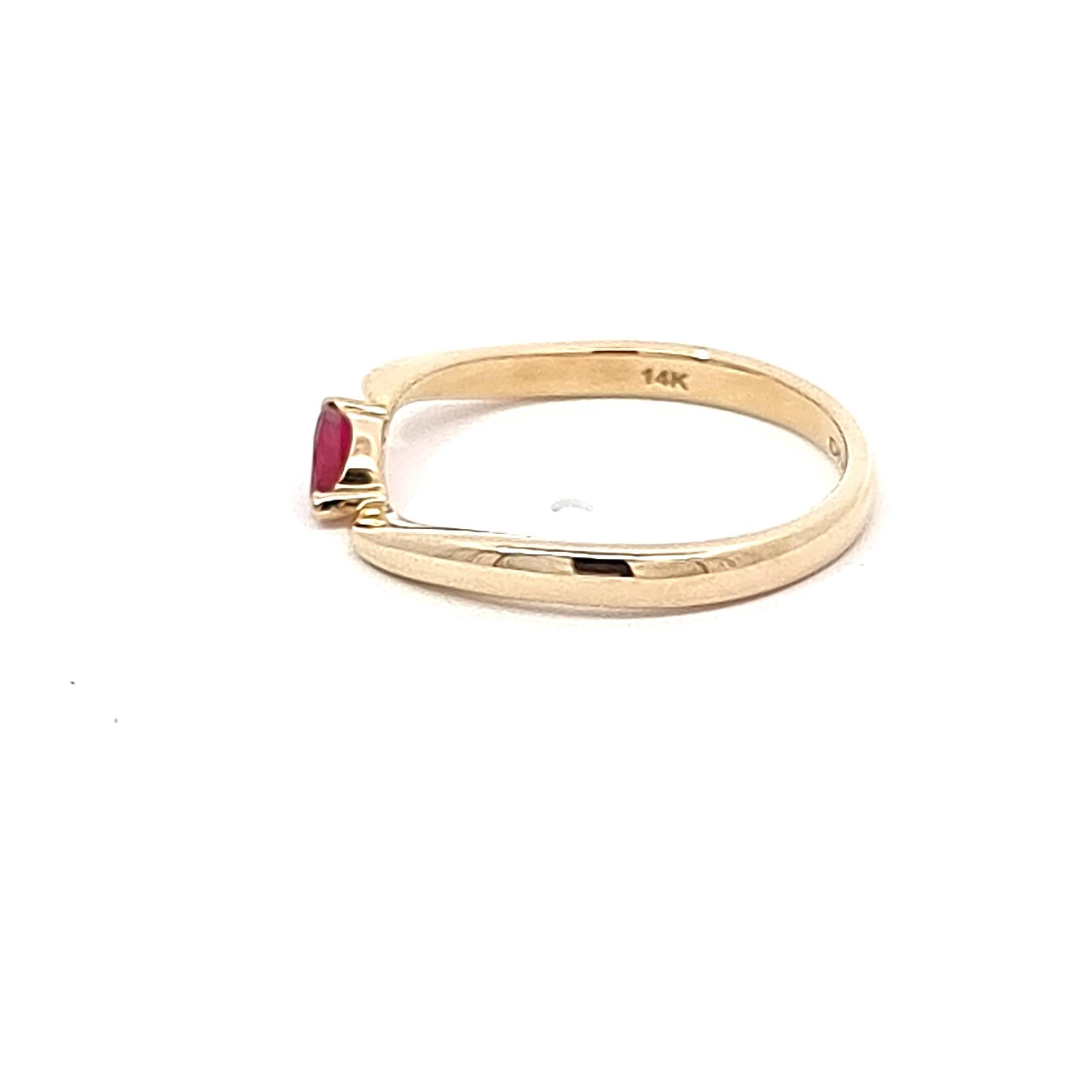 Bask in the glow of sophistication with our elegant Yellow Gold Ring, a masterpiece of finesse and warmth. The focal point is a resplendent marquise-cut Mozambique ruby, cradled in a unique twist setting that adds a touch of artistic flair. The warm