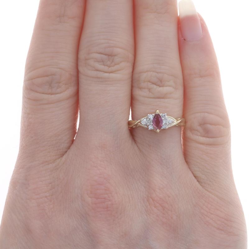Size: 6
Sizing Fee: Up 1 size for $25 or Down 1 size for $25

Metal Content: 14k Yellow Gold & 14k White Gold

Stone Information
Natural Ruby
Treatment: Heating
Carat(s): .32ct
Cut: Marquise
Color: Pinkish Red

Natural Diamonds
Carat(s): .10ctw
Cut: