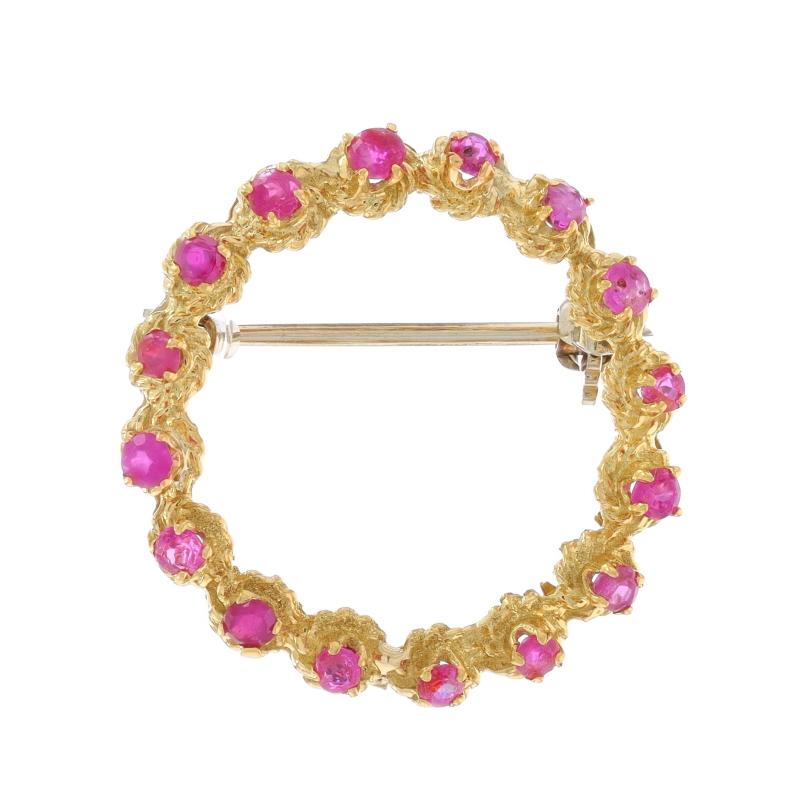 Metal Content: 18k Yellow Gold

Stone Information

Natural Rubies
Treatment: Heating
Carat(s): .98ctw
Cut: Round
Color: Pinkish Red

Total Carats: .98ctw

Style: Brooch
Fastening Type: Hinged Pin and Whale Tail Clasp
Theme: Wreath, Circle
Features: