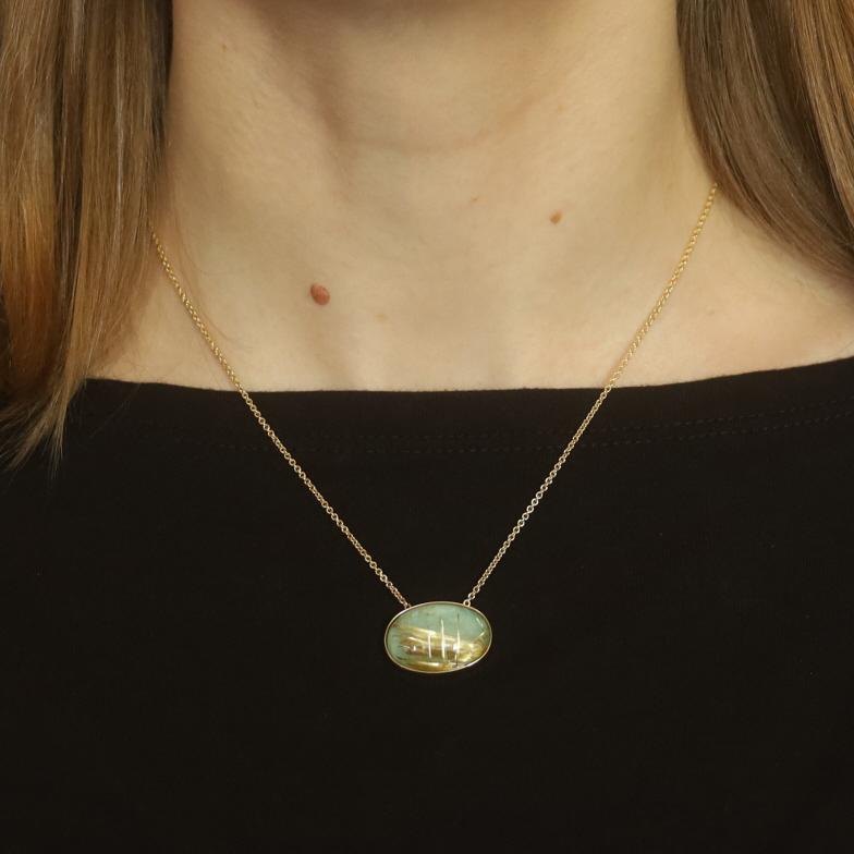 Metal Content: 14k Yellow Gold

Stone Information

Natural Rutilated Quartz
Cut: Oval Cabochon

Natural Amazonite
Cut: Oval

Style: Solitaire
Chain Style: Cable
Necklace Style: Chain
Fastening Type: Lobster Claw Clasp
Features: East-West Bezel Set