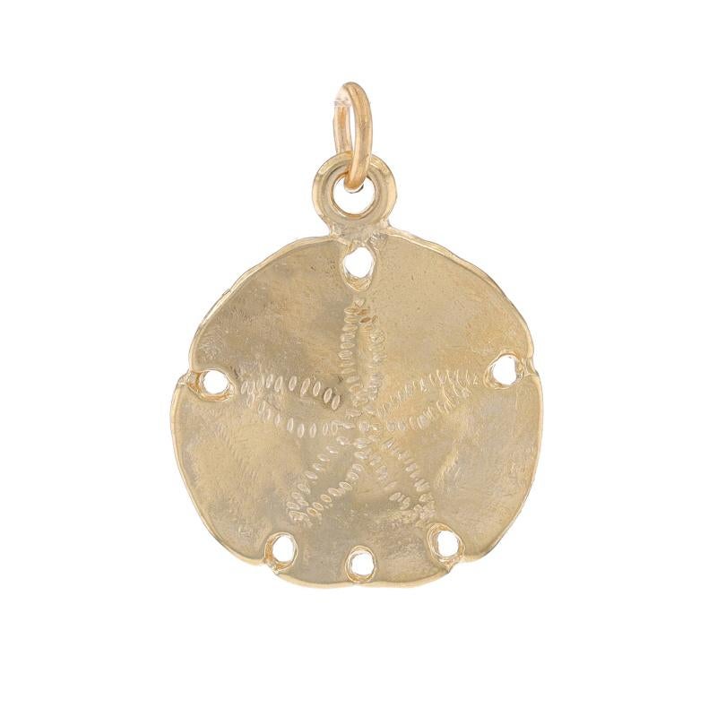 Metal Content: 14k Yellow Gold

Theme: Sand Dollar, Ocean Life, Beach Seashore Pendant
Features: Curved Silhouette with Etched & Open Cut Detailing

Measurements

Tall (from stationary bail): 25/32