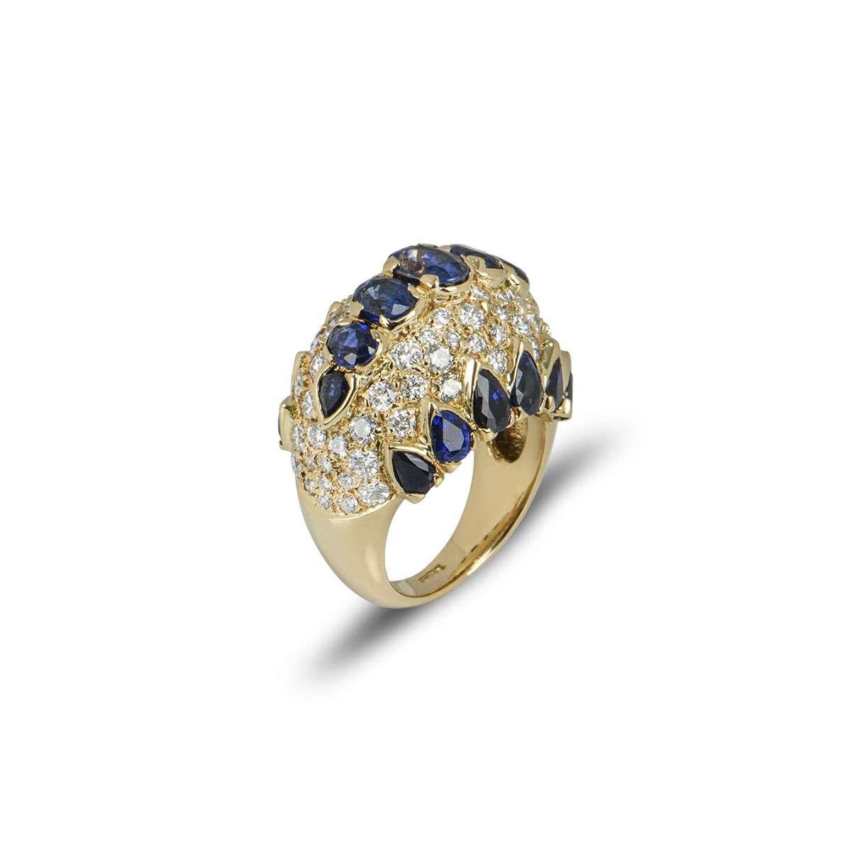 An 18k yellow gold sapphire and diamond dress ring. The bombe style ring is set with 3 rows of oval and pear cut blue sapphires, with round brilliant cut pave set diamonds in-between. The sapphires have a total weight of approximately 5.00ct and the