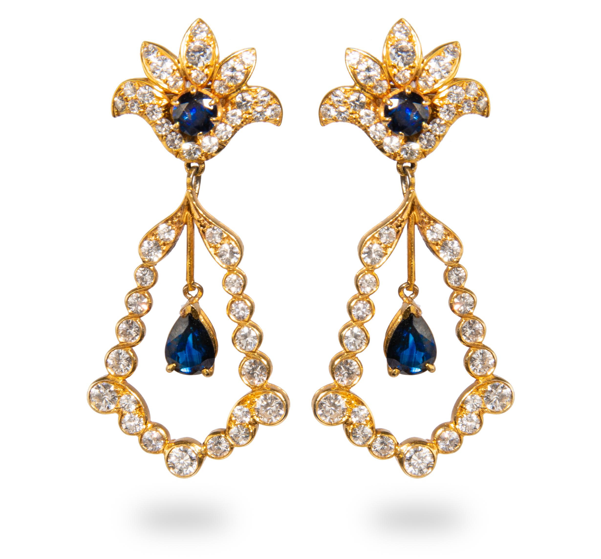 Yellow Gold, Sapphire and Diamond pair of earrings containing two pear shape mixed cut sapphires measuring approximately 7.00 x 5.20 x 3.10 mm, two round sapphires and 90 round brilliant cut diamonds weighing approximately 4.95 carats total.