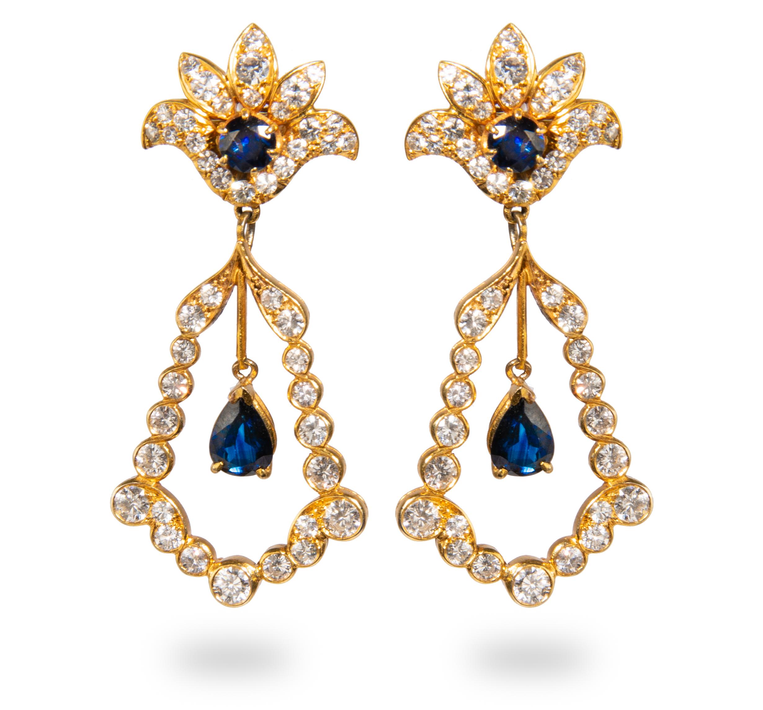 Yellow Gold, Sapphire and Diamond pair of earrings containing two pear shape mixed cut sapphires measuring approximately 7.00 x 5.20 x 3.10 mm, two round sapphires and 90 round brilliant cut diamonds weighing approximately 4.95 carats total.