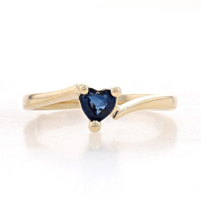 Size: 3 1/2
Sizing Fee: Up 2 sizes for $35 or Down 2 sizes for $30

Metal Content: 14k Yellow Gold

Stone Information
Natural Sapphire
Treatment: Heating
Carat(s): .30ct
Cut: Heart
Color: Blue

Total Carats: .30ct

Style: Bypass Solitaire
Theme: