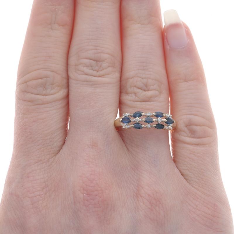 Size: 9
Sizing Fee: Up 2 sizes for $30 or Down 1 size for $30

Metal Content: 10k Yellow Gold & 10k White Gold

Stone Information

Natural Sapphires
Treatment: Heating
Carat(s): .91ctw
Cut: Marquise
Color: Blue

Natural Diamonds
Carat(s):