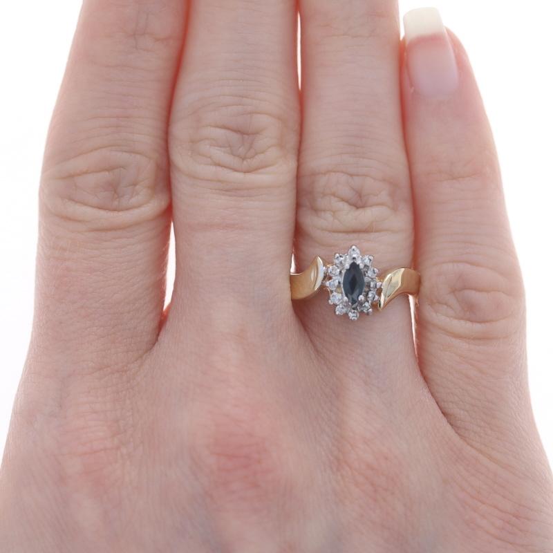 Yellow Gold Sapphire & Diamond Halo Bypass Ring 10k Marquise .41ctw

Stone Information:
Natural Sapphire
Treatment: Heating
Carat(s): .35ct
Cut: Marquise
Color: Greenish Blue

Natural Diamonds
Carat(s): .06ctw
Cut: Single
Color: H - I
Clarity: I1 -