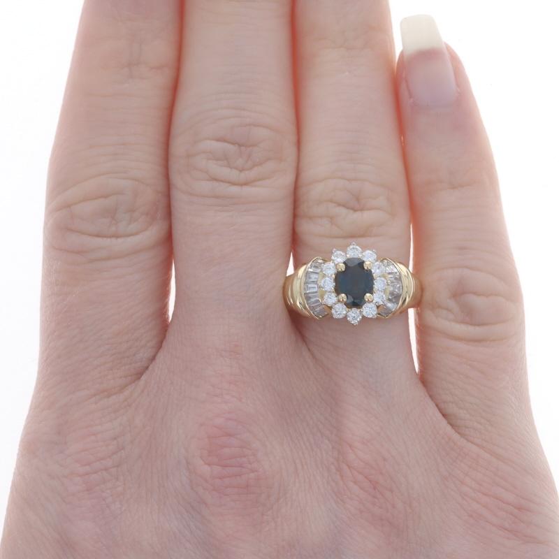 Size: 6 1/4
Sizing Fee: Up 1/2 a size for $40 or Down 1/2 a size for $40

Metal Content: 18k Yellow Gold & 18k White Gold

Stone Information
Natural Sapphire
Treatment: Heating
Carat(s): 1.10ct
Cut: Oval
Color: Blue

Natural Diamonds
Carat(s):