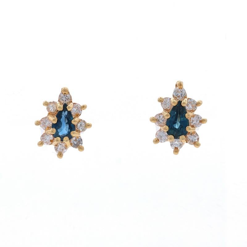 Metal Content: 14k Yellow Gold

Stone Information
Natural Sapphires
Treatment: Heating
Carat(s): .60ctw
Cut: Pear
Color: Blue

Natural Diamonds
Carat(s): .32ctw
Cut: Round Brilliant
Color: G - H
Clarity: SI2 - I1

Total Carats: .92ctw

Style: Halo