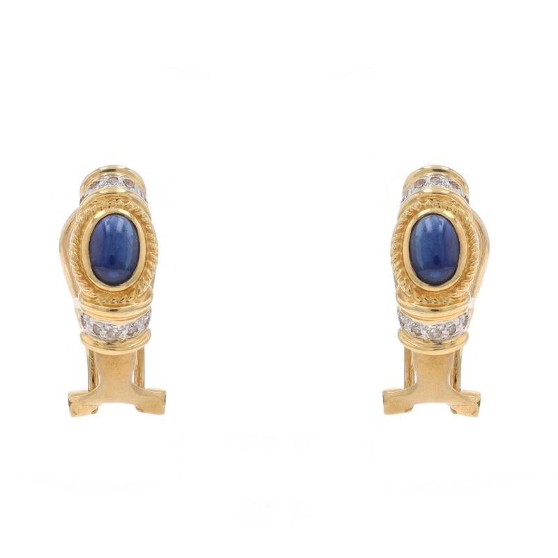 Metal Content: 14k Yellow Gold & 14k White Gold

Stone Information

Natural Sapphires
Treatment: Heating
Carat(s): 1.12ctw
Cut: Oval Cabochon
Color: Blue

Natural Diamonds
Carat(s): .12ctw
Cut: Single
Color: Champagne Brown
Clarity: SI2 - I1

Total