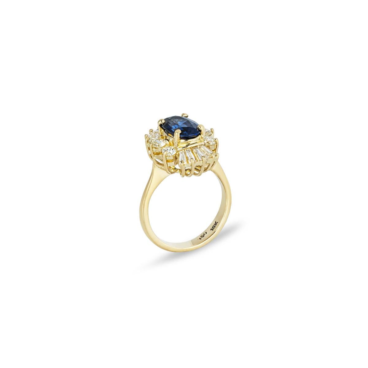 A beautiful 18k yellow gold sapphire and diamond dress ring. Set to the centre in a four prong mount is an oval cut sapphire weighing approximately 1.27ct and displaying a dark blue hue. Accentuating the sapphire are 6 round brilliant cut diamonds