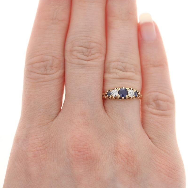 Size: 5
Sizing Fee: Up 2 sizes for $40

Era: Victorian
Date: 1896

Metal Content: 18k Yellow Gold

Stone Information

Natural Sapphires
Treatment: Heating
Carat(s): .64ctw
Cut: Round
Color: Blue

Natural Diamonds
Carat(s): .28ctw
Cut: