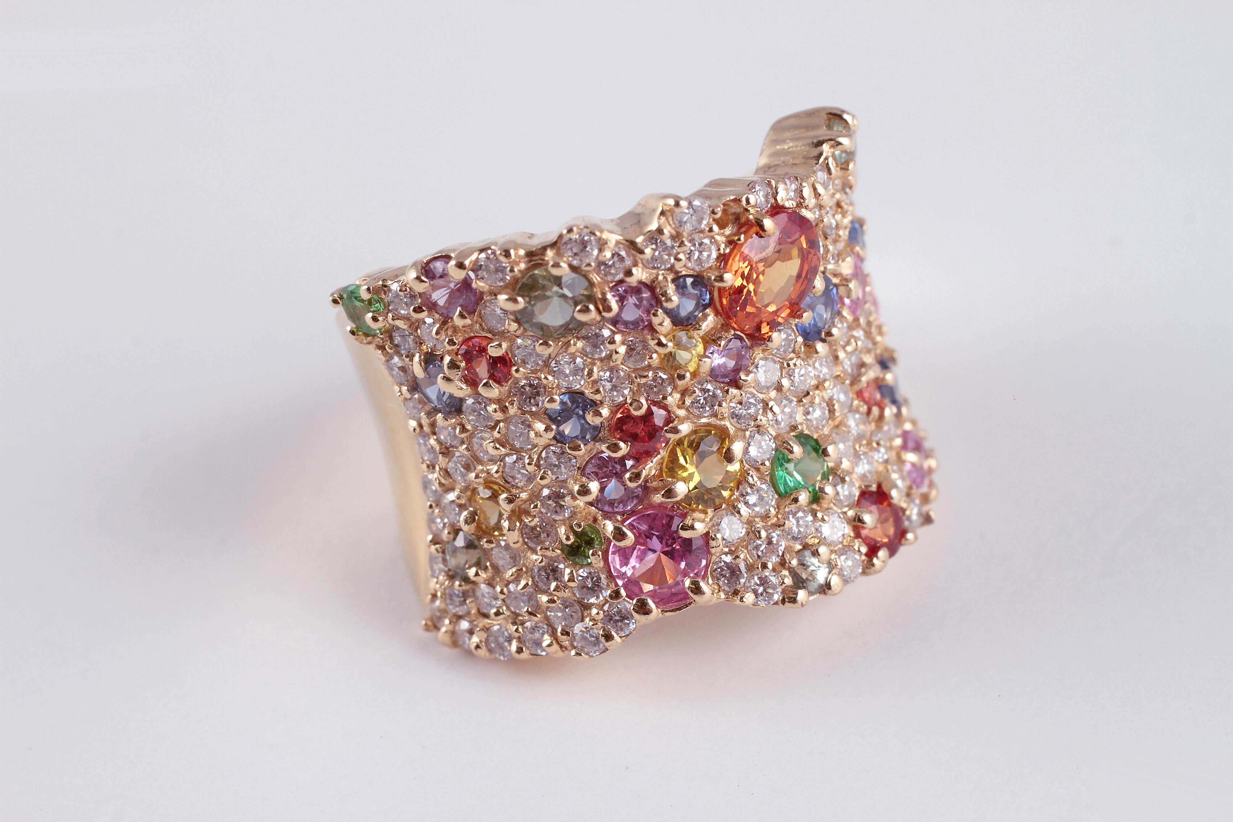 How fun is this! Composed of 14 karat yellow gold, this dazzling ring is by Effy from the Watercolors collection and features round diamonds and a sprinkling of multi color and multi size sapphires. In a size 7 1/2.