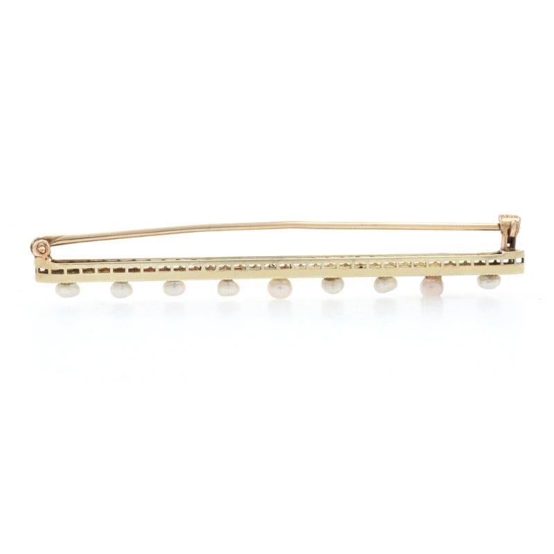 Era: Art Deco
Date: 1920s - 1930s

Metal Content: 14k Yellow Gold & 14k White Gold

Stone Information
Genuine  Seed Pearls

Style: Bar Brooch 
Fastening Type: Hinged Pin and Locking C-Clasp
Features:  Filigree design with milgrain