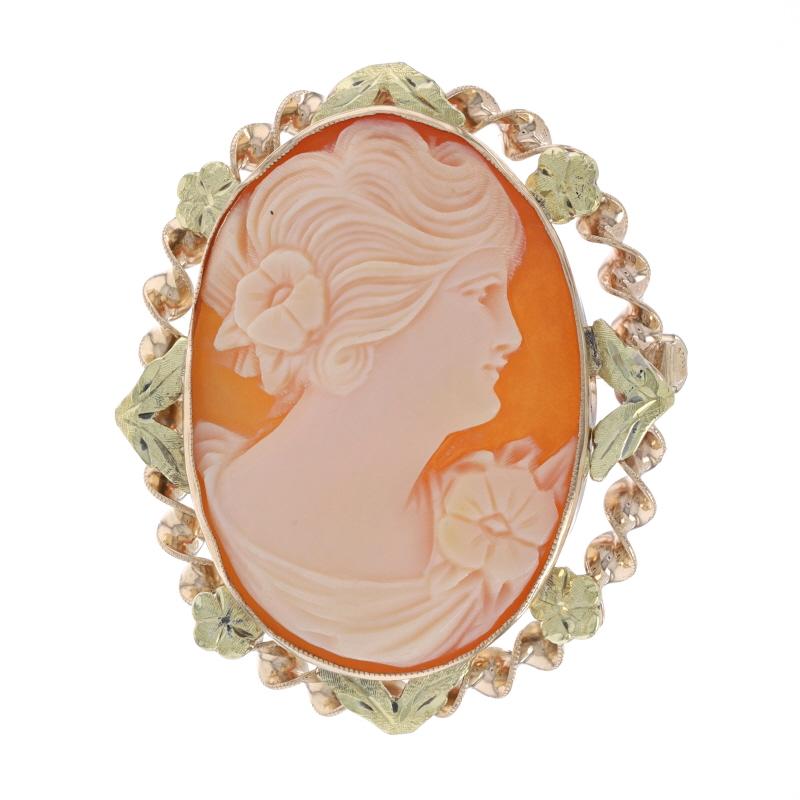 Era: Vintage

Metal Content: 10k Yellow Gold & 10k Green Gold

Stone Information
Natural Shell
Cut: Carved Cameo

Style: Brooch/Pendant 
Fastening Type: Hinged Pin and Whale Tail Bullet Clasp
Theme: Silhouette 
Features: Etched & milgrain