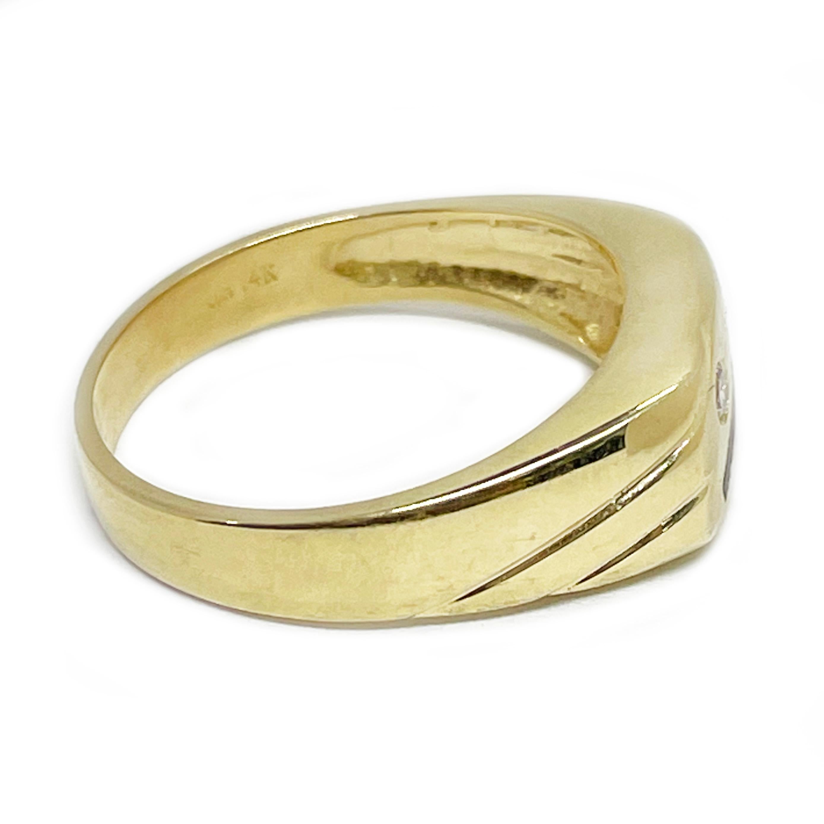 14 Karat Yellow Gold Signet Diamond Ring. The ring features two diagonal stripes painted black on the top with a single round diamond flush set on a satin finish. The rest of the ring has a smooth shiny finish. The diamond measures 2.2mm. On the
