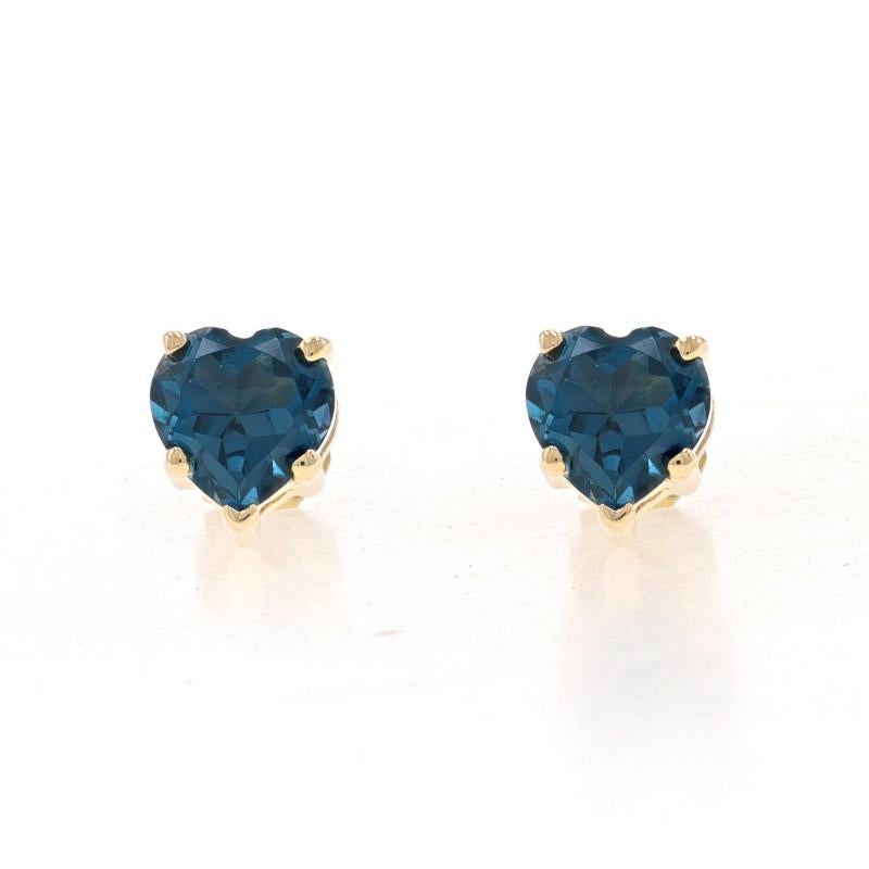 Metal Content: 10k Yellow Gold

Stone Information
Simulated London Blue Topaz
Cut: Heart

Style: Stud
Fastening Type: Butterfly Closures
Theme: Love

Measurements
Tall: 1/4