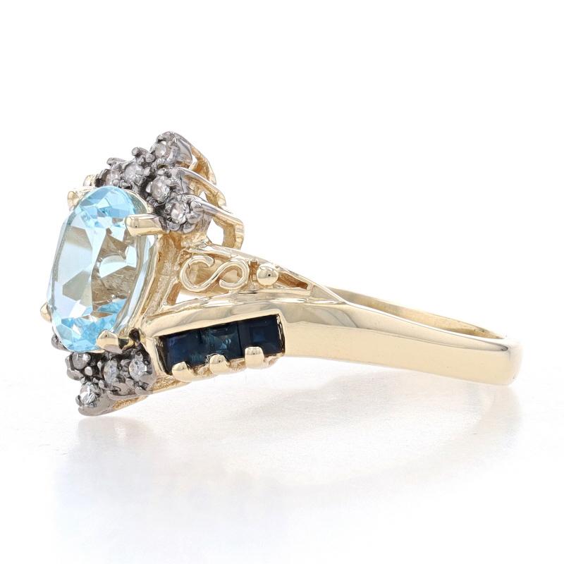 Yellow Gold Sky Blue Topaz, Sapphire, & Diamond Bypass Ring - 10k Oval 2.07ctw In Excellent Condition For Sale In Greensboro, NC