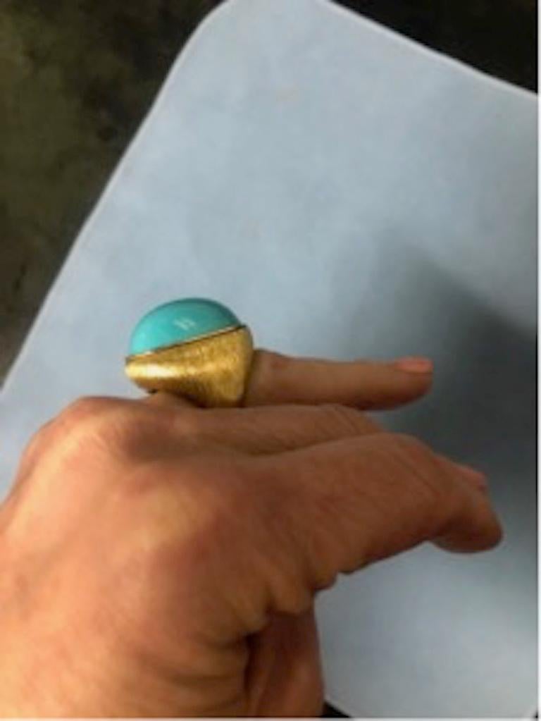 An elegant and timeless Sleeping Beauty turquoise ring from the house of Henry Dunay.  This stunning ring has a “Sabi “finish that is a signature finish from Mr. Dunay.  This rare cabochon sleeping beauty turquoise is set in 18K yellow gold