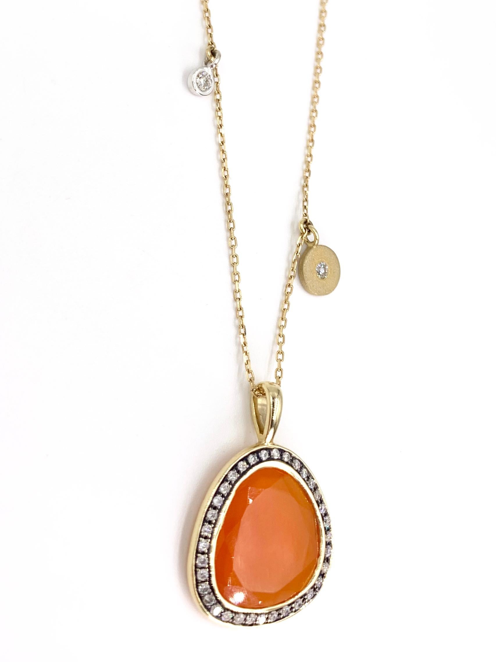 Fashionable and wearable, this 14 karat yellow gold pendant necklace features an organic shaped sliced vivid fire opal surrounded by white diamonds with two delicate accent diamonds attached to the oval link chain. White round brilliant diamonds