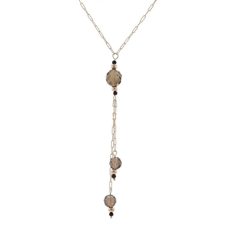Metal Content: 10k Yellow Gold

Stone Information

Natural Smoky Quartz
Cut: Beads
Color: Brown

Natural Onyx
Cut: Beads
Color: Black

Style: Station Chain Lariat 
Chain Style: Crinkle
Fastening Type: Spring Ring Clasp

Measurements

Length: 15