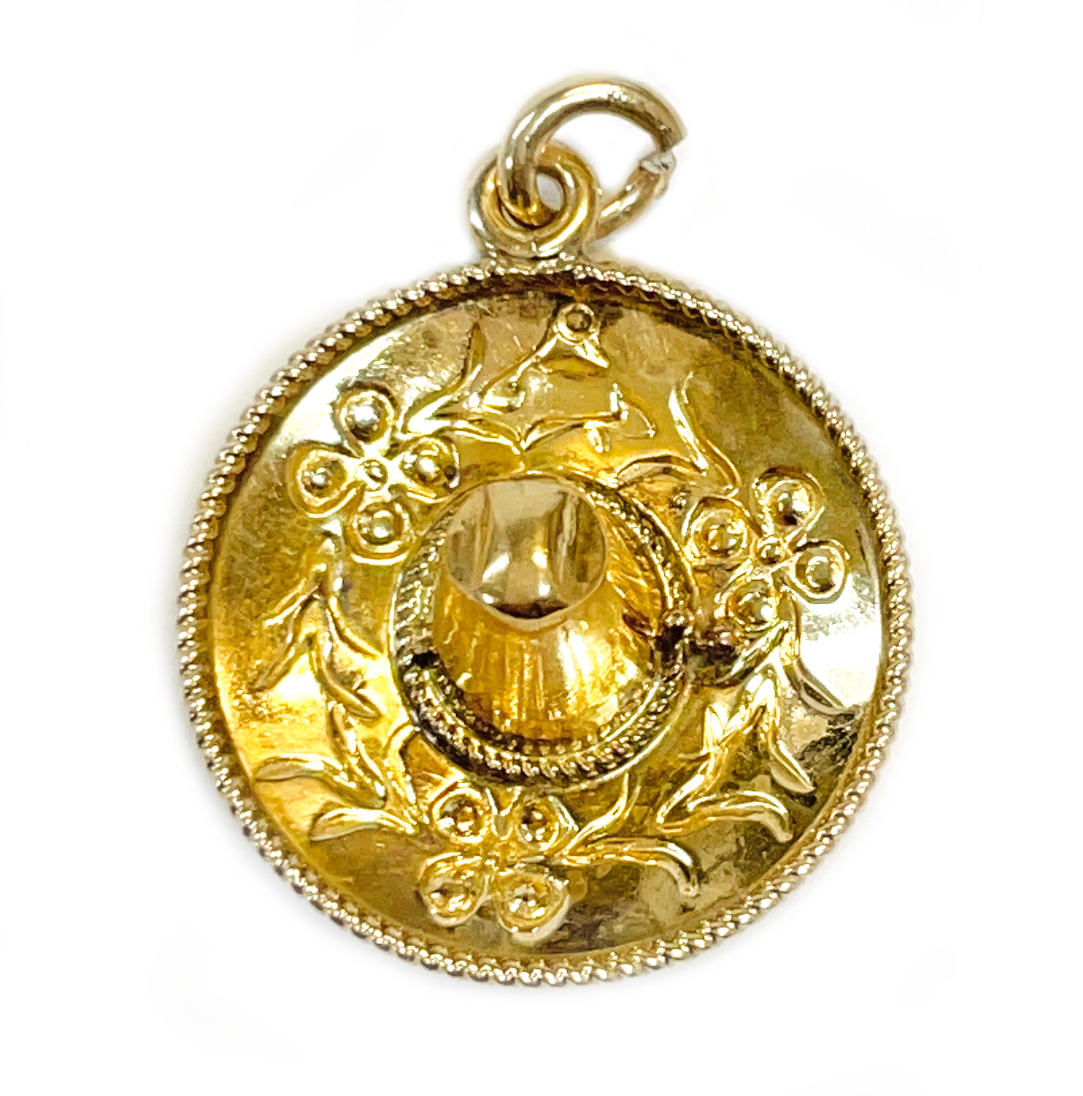 14 Karat yellow gold sombrero charm pendant. This lovely sombrero pendant offers nice detail with flowers and leaves design and rope trim. The pendant measures 17.9mm wide x 5.8mm tall. Stamped on the bottom is the 14K. This would look great on a