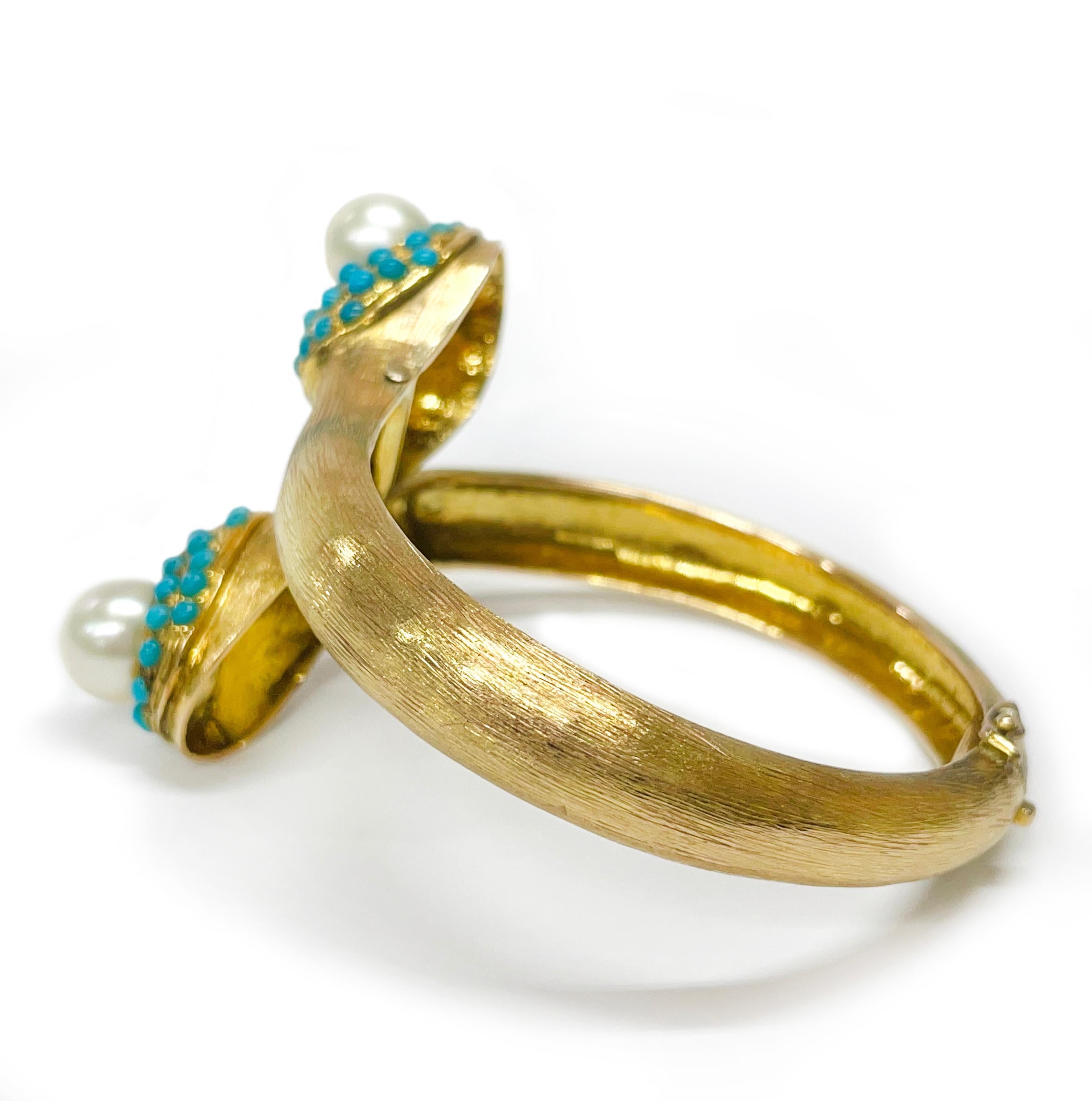 14 Karat Yellow Gold Pearl Turquoise Cuff. The bracelet cuff features two 9.5mm South Sea Pearls and sixty-six 2.5mm Turquoise cabochons on the ends of the cuff. The cuff has a brushed texture on the front side and smooth finish on the inside with a