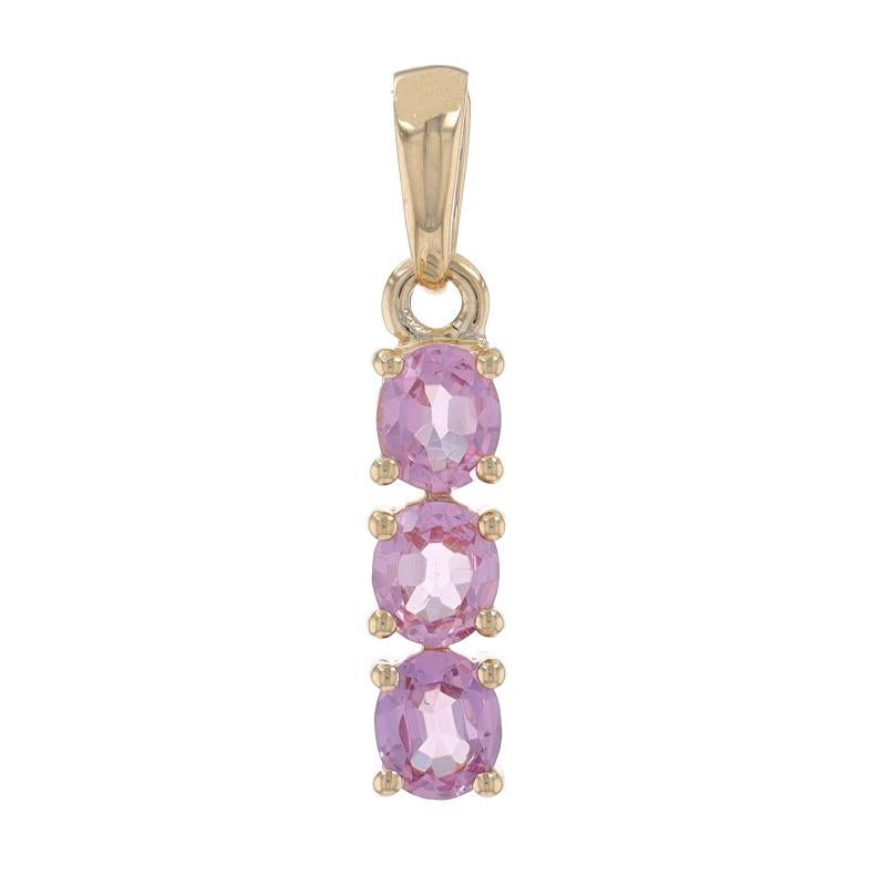 Metal Content: 10k Yellow Gold

Stone Information
Natural Spinel
Carat(s): .75ctw
Cut: Oval
Color: Light Purplish Pink

Total Carats: .75ctw

Style: Three-Stone Journey
Theme: Love

Measurements
Tall (from stationary bail): 11/16