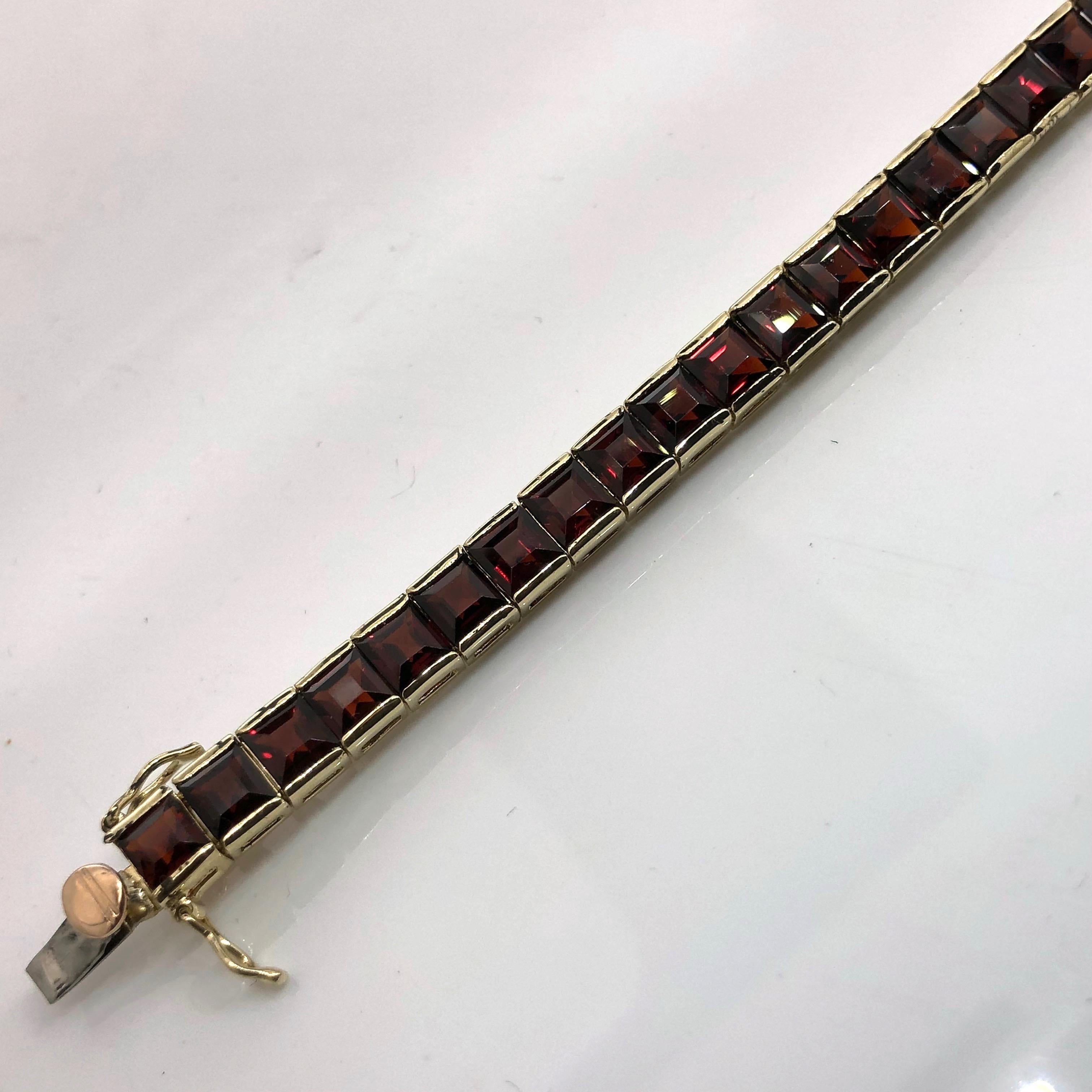 Rare find! 14 carat yellow gold square link tennis bracelet set with 5 mm carre cut deep red Bohemian garnets .
Box clasp with two safety clips,
Bracelet length is 18 cm, closed diameter is 5.8 cm, thickness is 5.4mm.
Weight of the bracelet is 13.2
