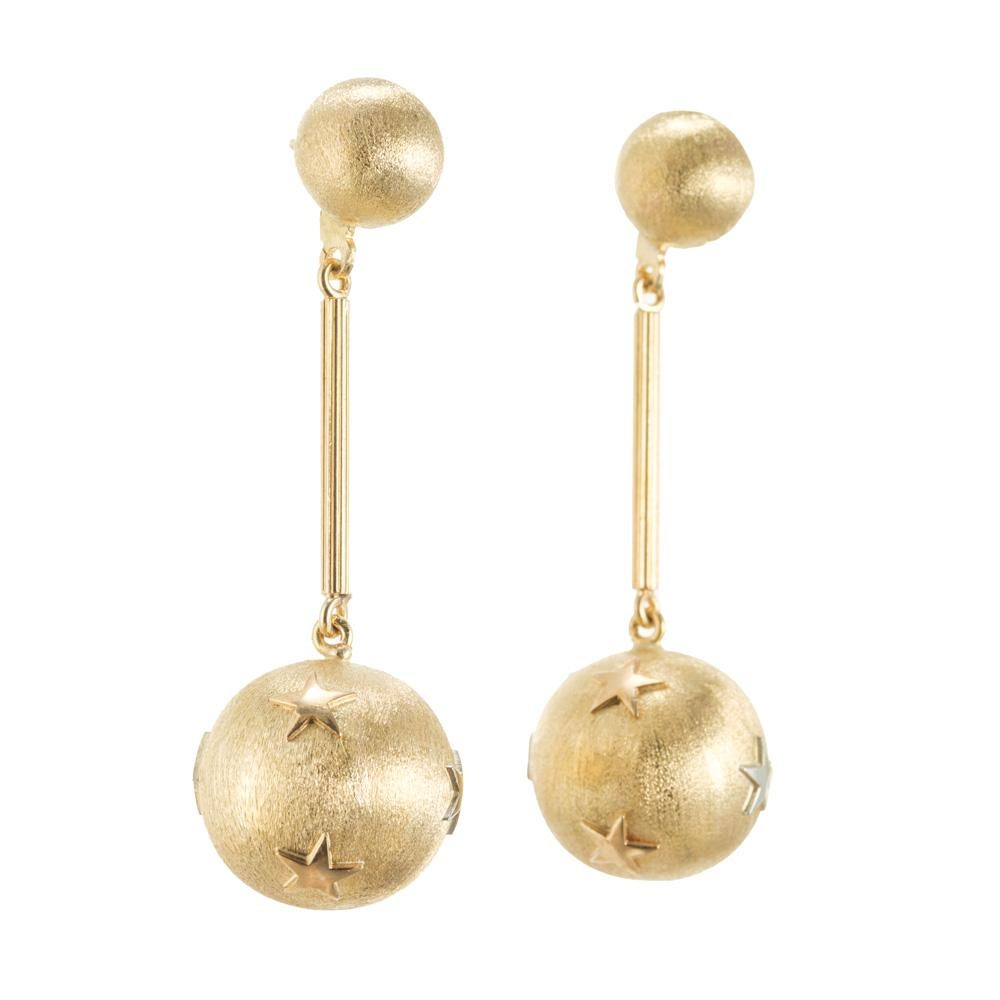 Vintage 1970's gold ball dangle drop earrings. 4 Textured 14k yellow gold balls separated by gold posts. The two bottom balls have polished star designed on them.  

14k yellow gold 
Stamped: 14k
11.1 grams
Top to bottom: 49.8mm or 1.96