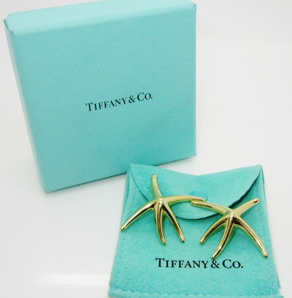 (27796)

Tiffany & Co 18k Yellow Gold Star Fish Earrings, measuring 2 inch in diameter and having posts. 

Excellent condition and come in a Tiffany gift box.

Crafted in 18K yellow gold; measures 1-5/8 x 2 inches; weight 9.19 g.

Signed: T&CO 
E.