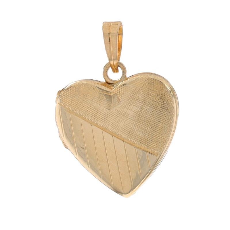 Metal Content: 14k Yellow Gold

Style: Locket
Theme: Heart, Love
Features: Etched & Crosshatch Detailing; Two Photo Frames

Measurements
Tall (from stationary bail): 19/32