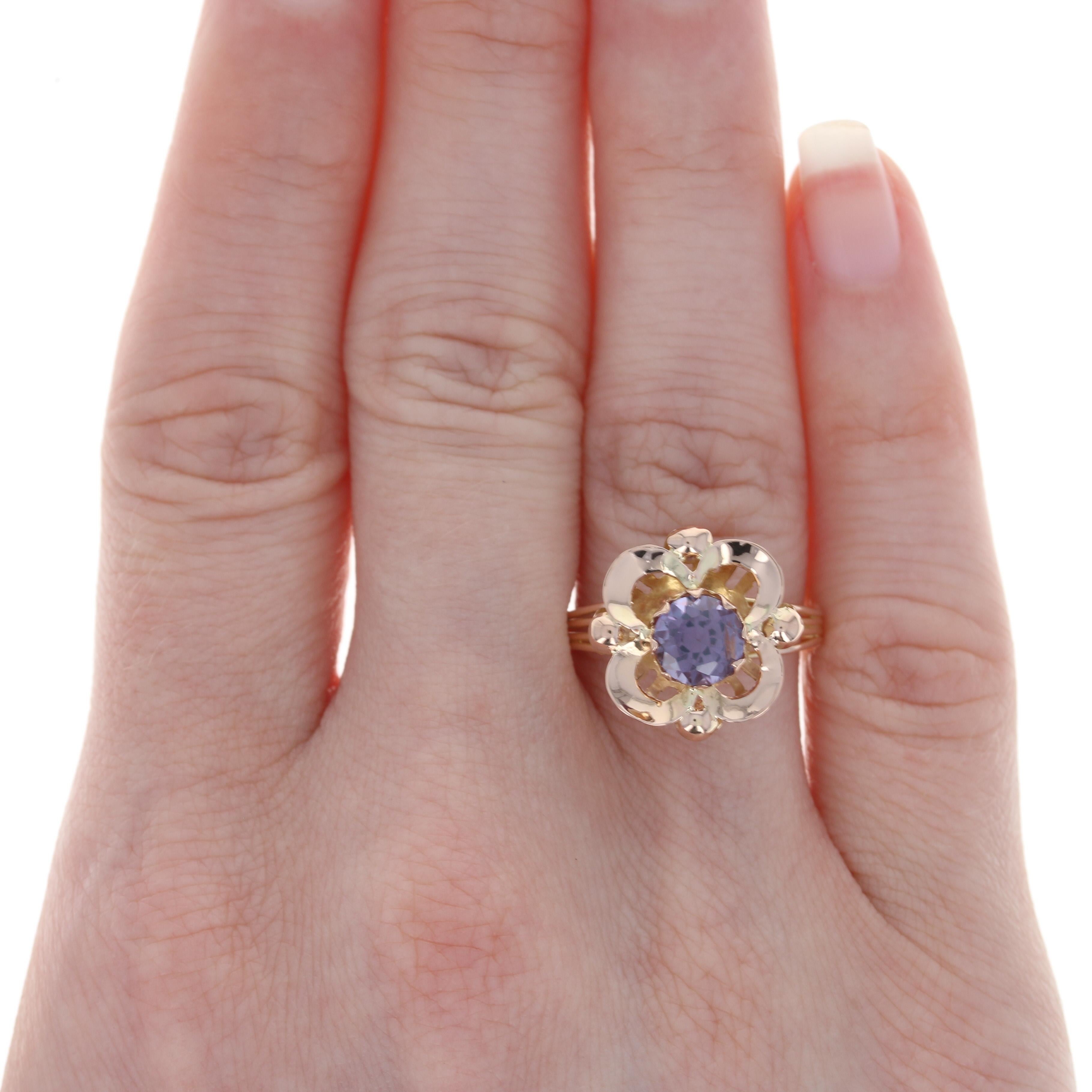 Size: 9
Sizing Fee: Down 3 sizes for a $25 fee or up 2 sizes for a $30 fee

Metal Content: 18k Yellow Gold

Stone Information: 
Synthetic Color Change Sapphire
Carat: 1.40ct
Cut: Round
Diameter: 6.5mm

Style: Solitaire
Theme: Flower

Face Height