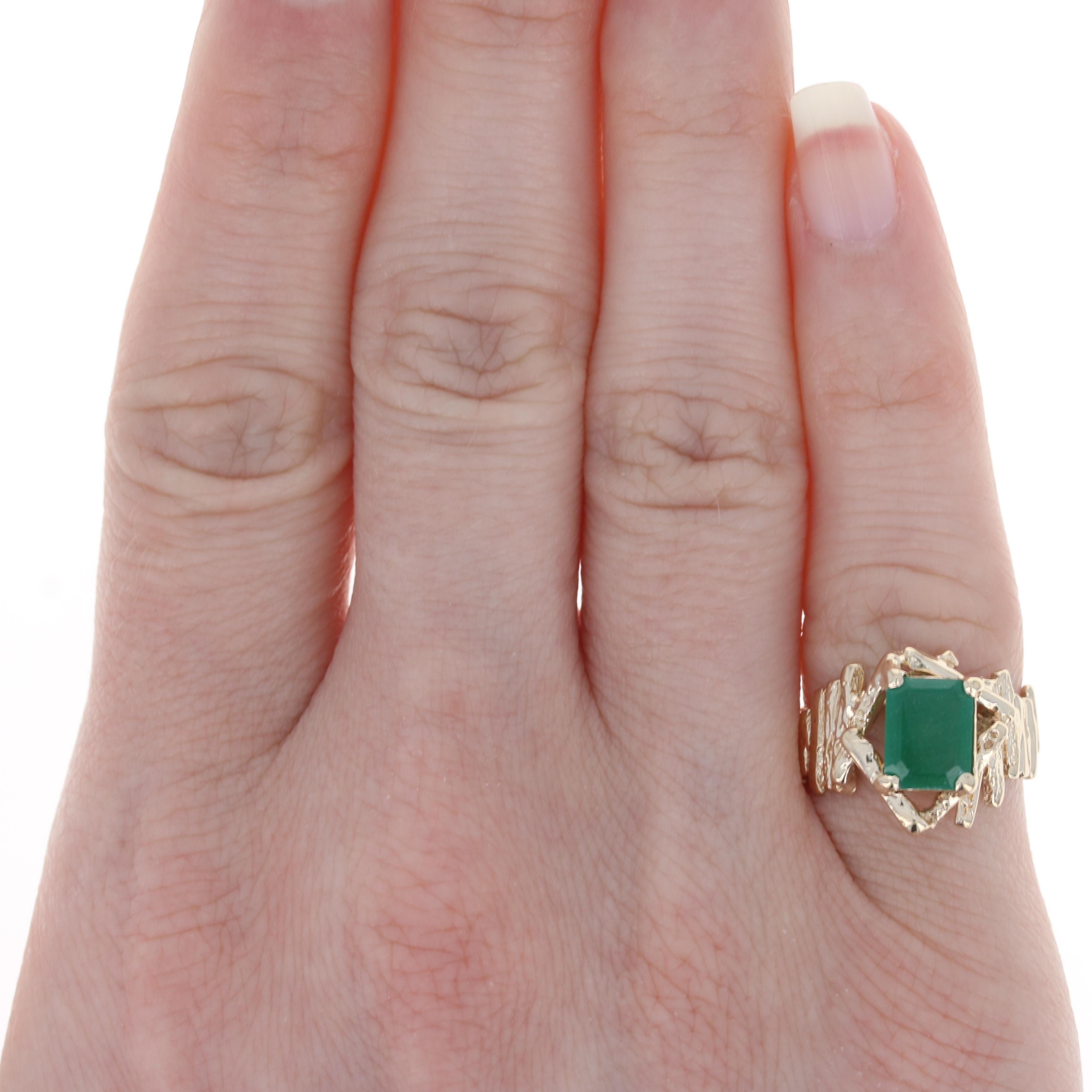 Size: 4 1/2

Metal Content: 14k Yellow Gold

Stone Information
Synthetic Emerald
Carat: 1.33ct
Cut: Emerald 
Color: Green 
Size: 8.2mm x 6.1mm

Style: Solitaire
Features: Textured

Measurements
Face Height (north to south): 9/16