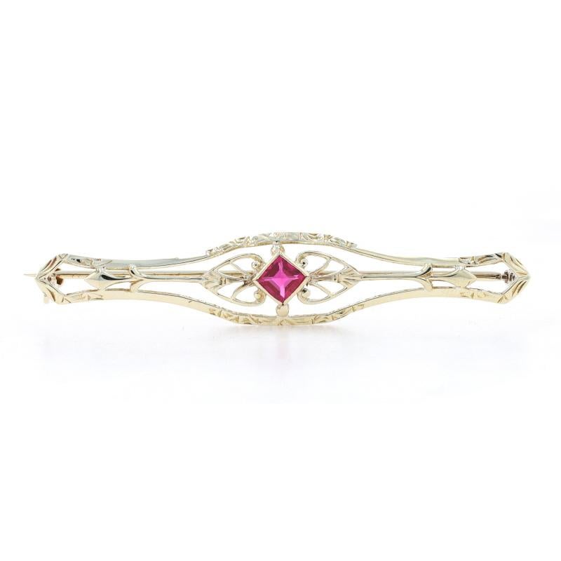 Era: Art Deco
Date: 1920s - 1930s

Metal Content: 14k Yellow Gold

Stone Information

Synthetic Ruby
Carats: .40ct
Cut: Square
Color: Red

Total Carats: .40ct

Style: Solitaire Brooch 
Fastening Type: Hinged Pin and Locking C-Clasp
Features:  Open