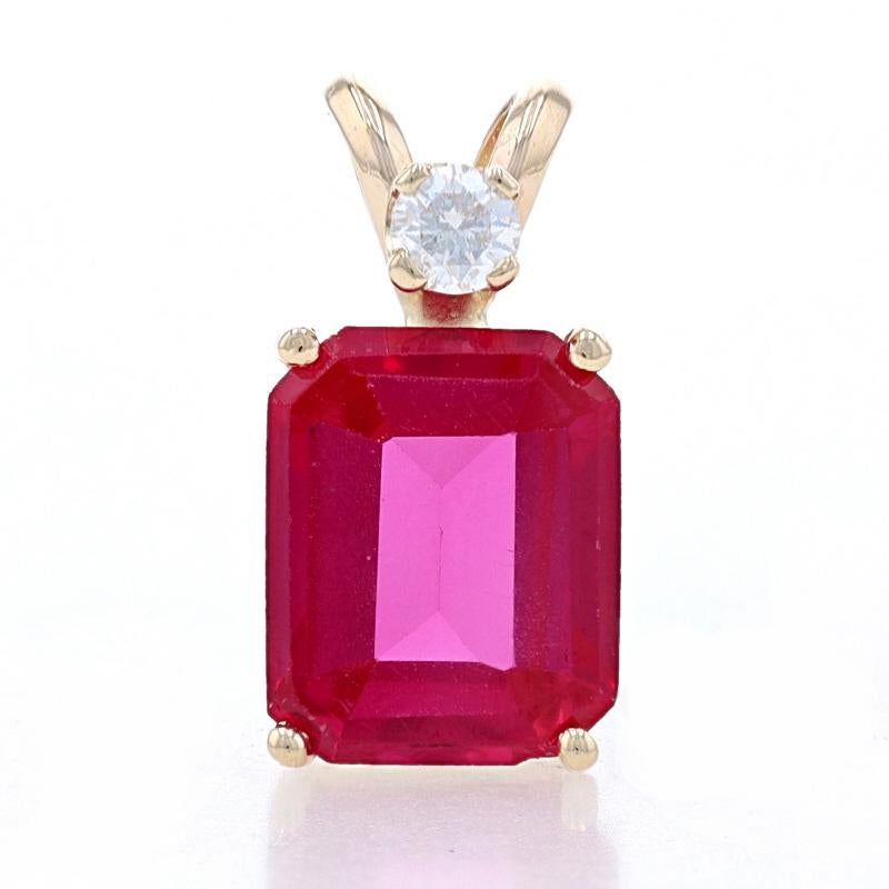 Metal Content: 14k Yellow Gold

Stone Information
Synthetic Ruby
Carat(s): 3.00ct
Cut: Emerald 
Color: Red

Natural Diamond
Carat(s): .09ct
Cut: Round Brilliant 
Color: F 
Clarity: I1

Total Carats: 3.09ctw

Measurements
Tall (from stationary bail):