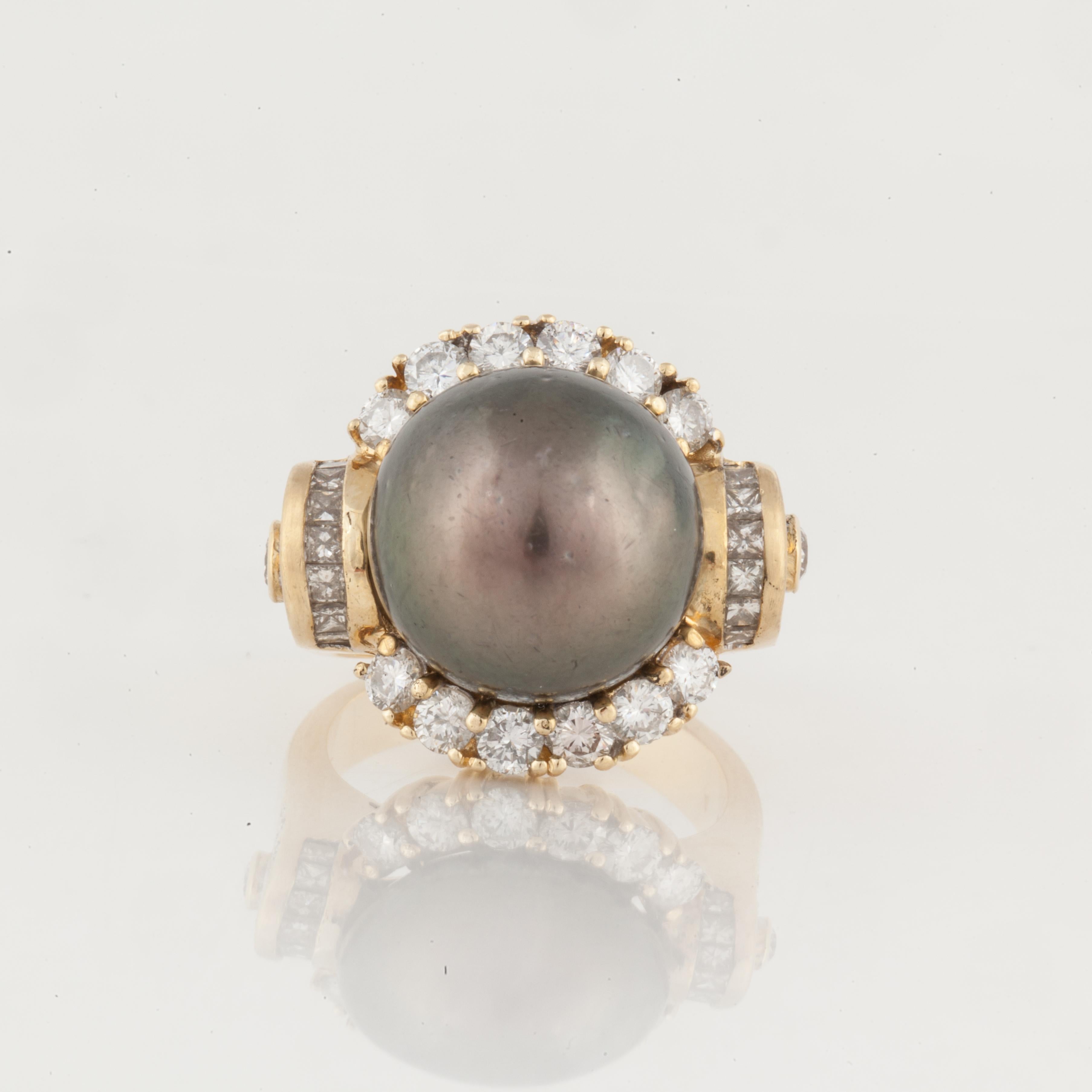 18K yellow gold cultured Tahitian pearl and diamond ring.  The pearl measures 14mm and is surrounded by 46 round diamonds that total 2.30 carats; I-J color and SI-1 clarity.  Ring is currently a size 7 1/2.  Measures 7/8 inches by 13/16 inches and